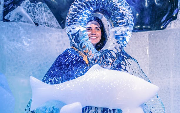 Berlin Icebar patrons enjoying drinks in a frosty setting, showcasing unique ice sculptures and vibrant lighting.