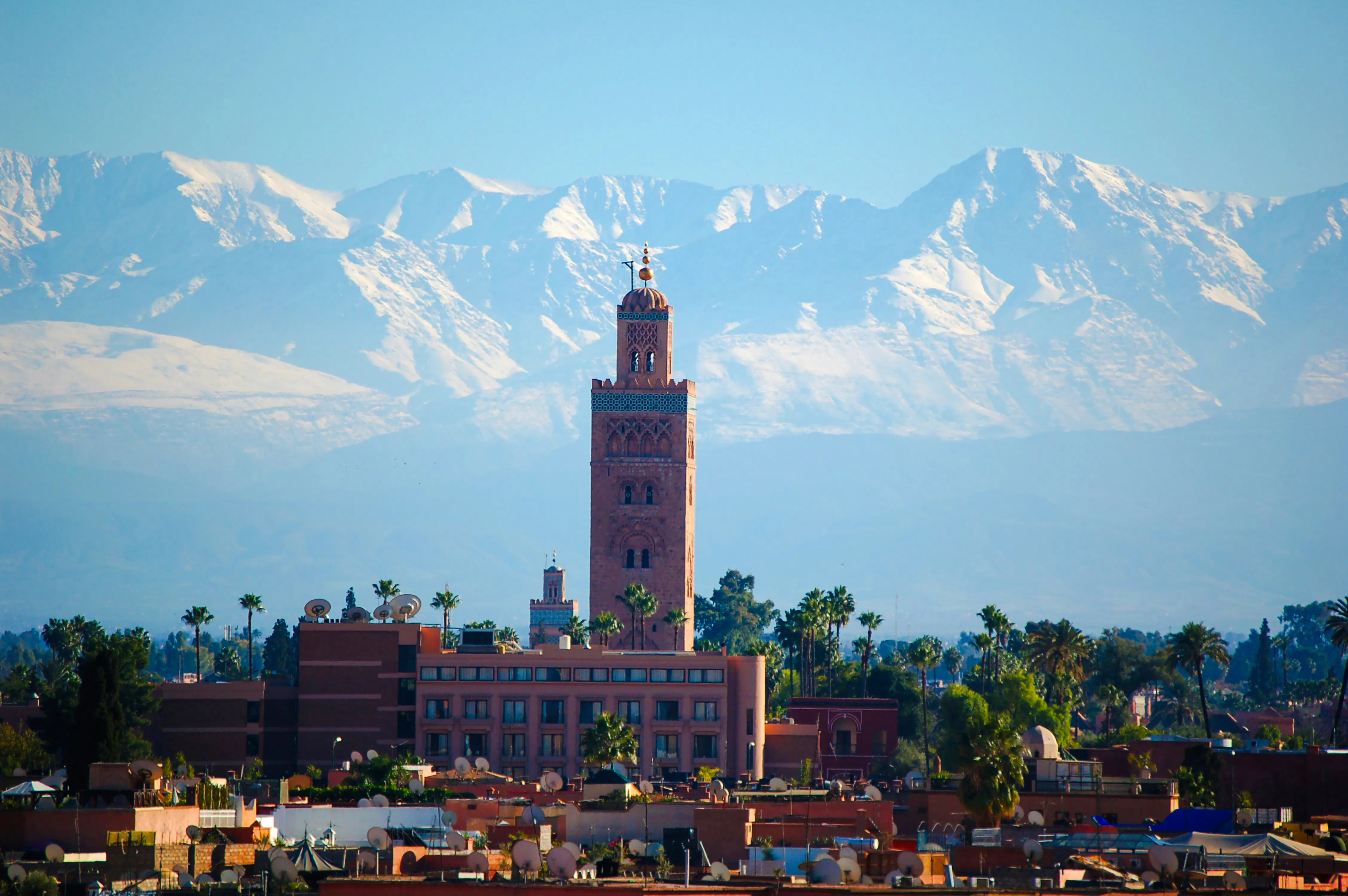 Koutoubia Mosque with Atlas Mountains in Marrakech, Morocco.