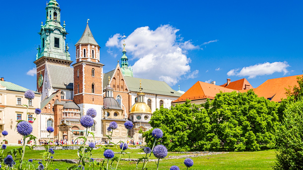Royal Wawel Castle in Krakow with vibrant gardens and historic architecture.