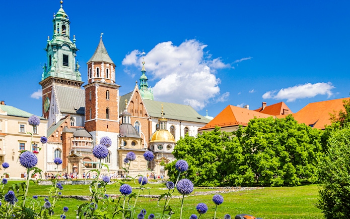 Royal Wawel Castle in Krakow with vibrant gardens and historic architecture.