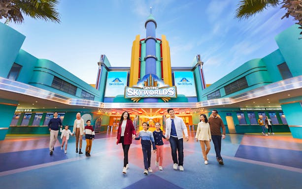 Families walking outside Genting Skyworlds Theme Park entrance.