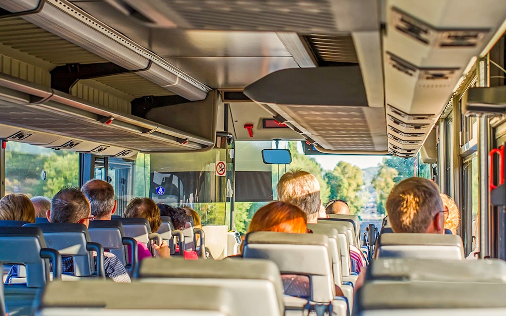Tourists on a bus heading to Krka Waterfalls from Split, Croatia.