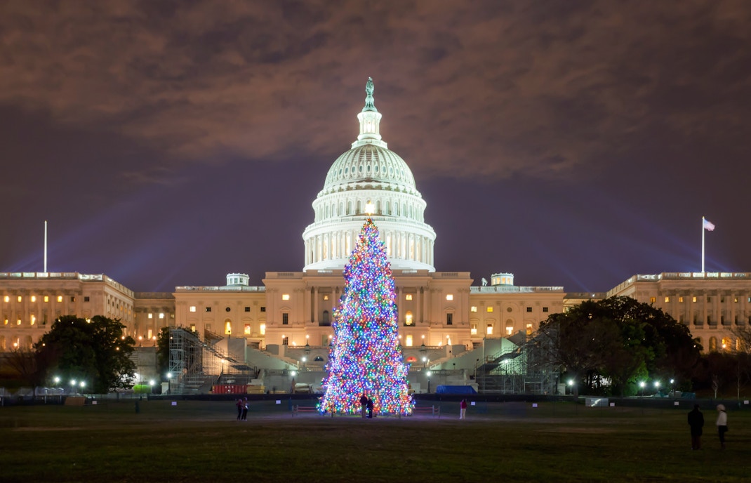 U.S. Capitol with Christmas tree lit up at night, Washington DC.
