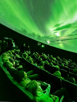 Visitors watching Northern Lights display at Perlan Museum, Reykjavik.