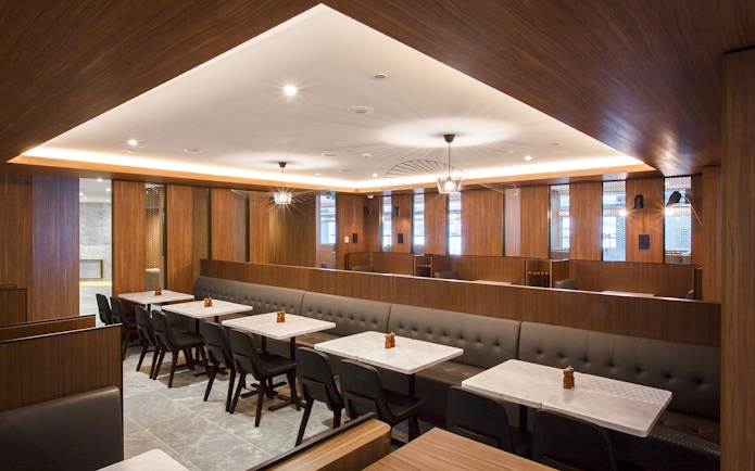 Plaza Premium Lounge seating area with tables and chairs in Melbourne airport.