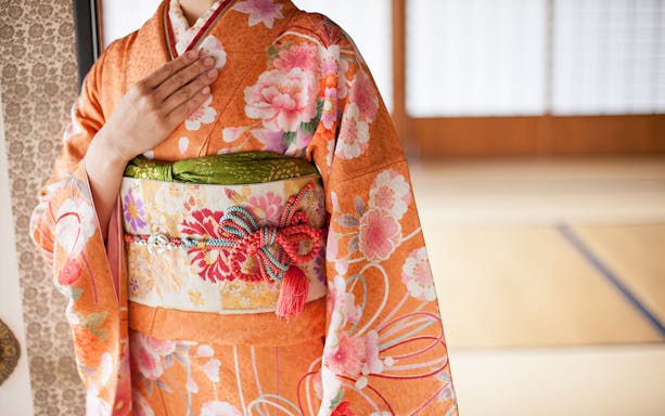 Maiko kimono detail with floral patterns during makeover experience in Kyoto.