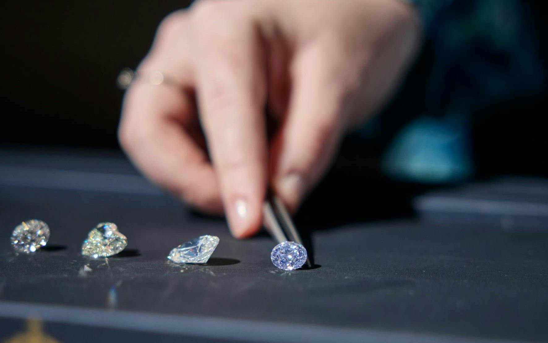 Selecting diamonds with tweezers at Royal Coster Diamonds.