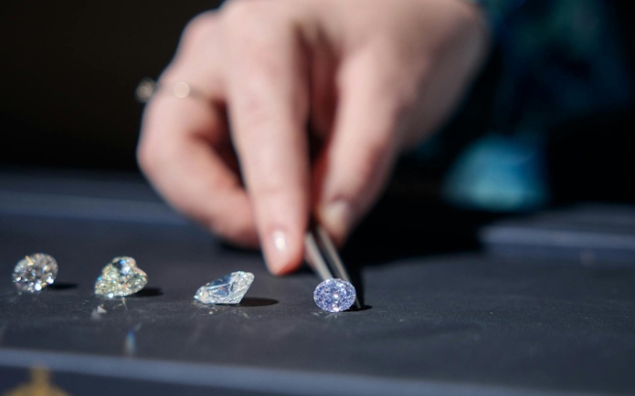 Selecting diamonds with tweezers at Royal Coster Diamonds.