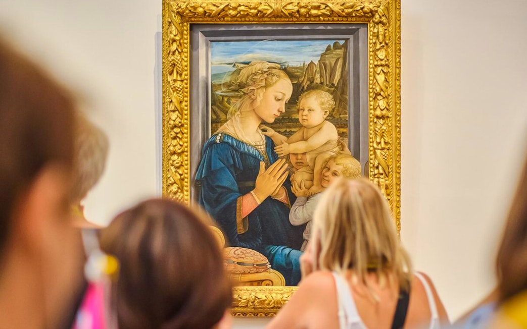 Visitors viewing Lippi's Madonna and Child at Accademia Gallery, Florence.
