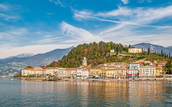 Bellagio waterfront with colorful buildings and hills on Lake Como, Italy.