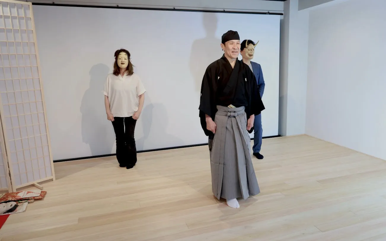 Noh performers in traditional attire during a workshop in Kyoto.