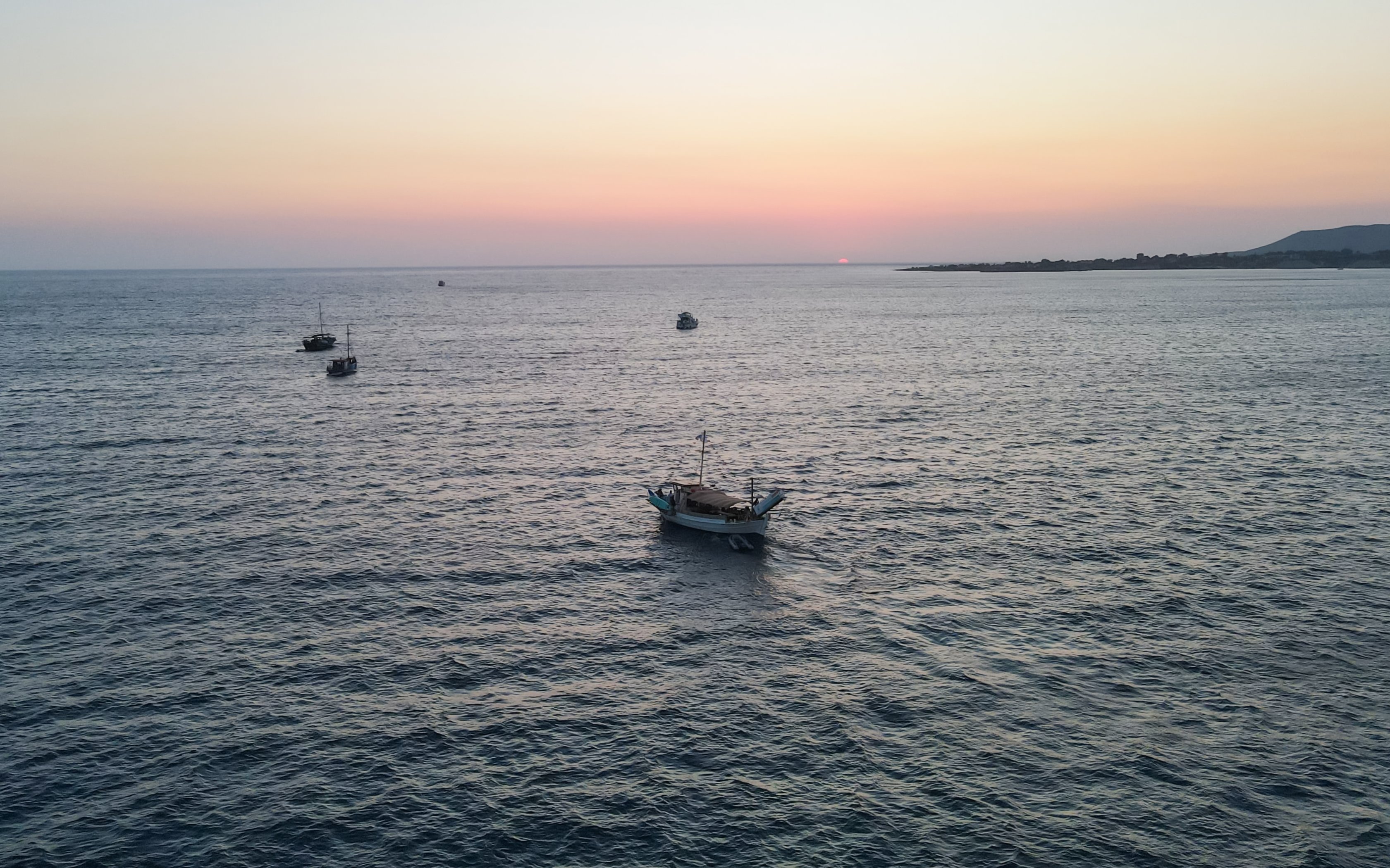 Boats sailing during sunset on a cruise from Kefalonia.