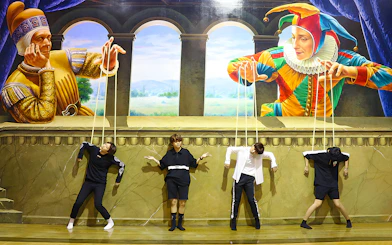 Visitors pose as marionettes in front of a puppet-themed mural at Art in Paradise Pattaya.