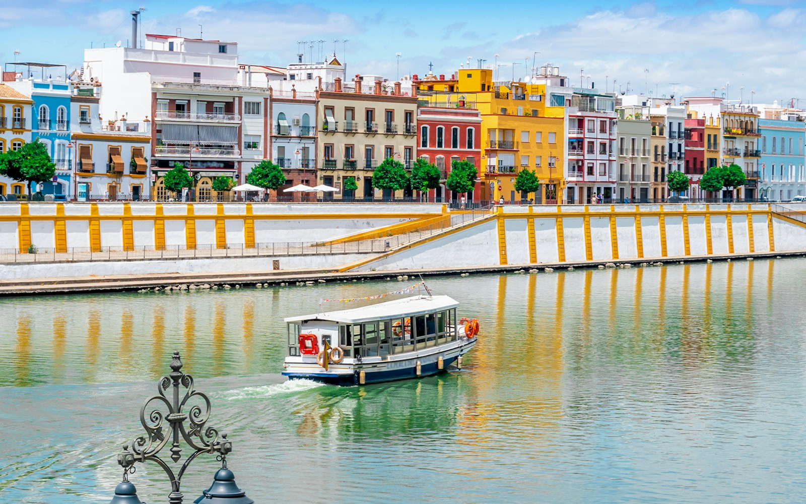 Boat cruise on Guadalquivir river in city center of Seville, Spain
