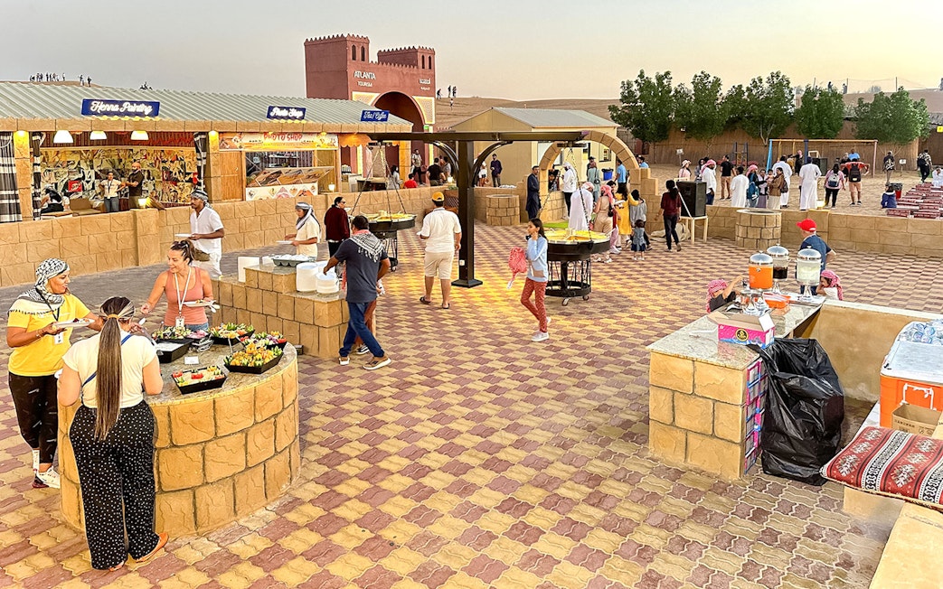 Buffet dinner setup with diverse food options at Dubai desert safari.