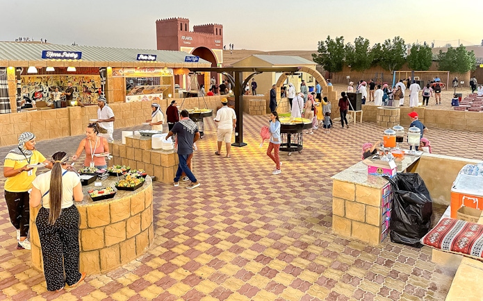 Buffet dinner setup with diverse food options at Dubai desert safari.