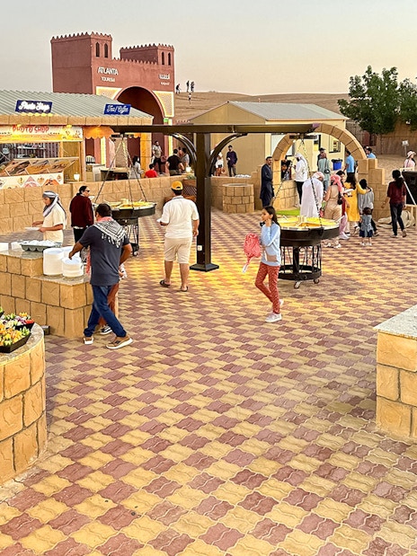 Buffet dinner setup with diverse food options at Dubai desert safari.