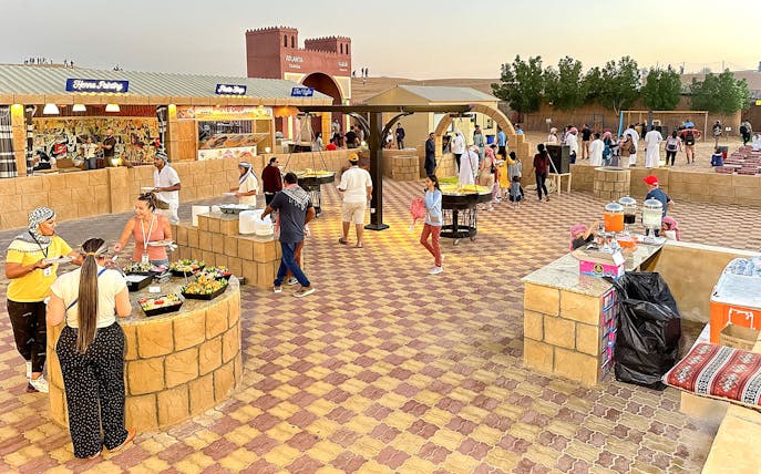 Buffet dinner setup with diverse food options at Dubai desert safari.