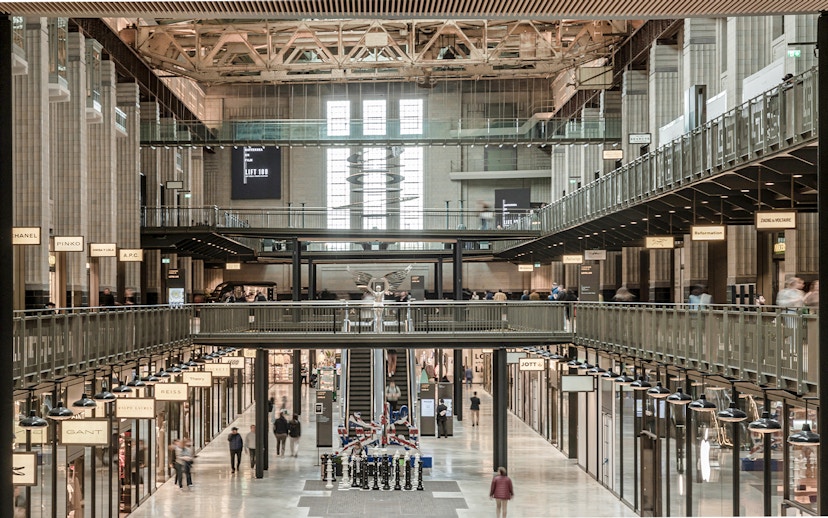 Interior view of New Battersea Power Station with shops and walkways.
