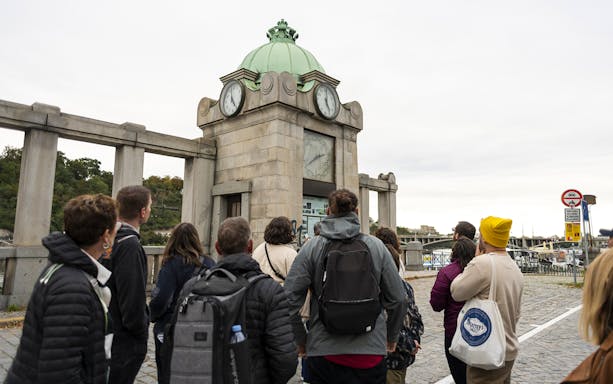 Guests viewing historic clock tower during Prague city tour.