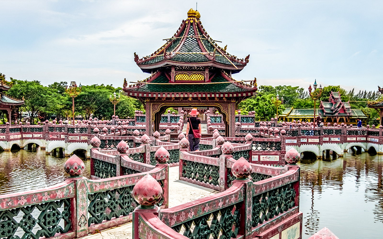 Temple pavilion on a lake with intricate bridge, Ancient Siam, Thailand.