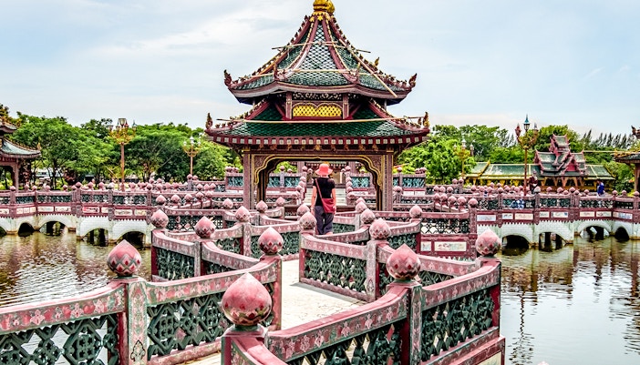 Temple pavilion on a lake with intricate bridge, Ancient Siam, Thailand.