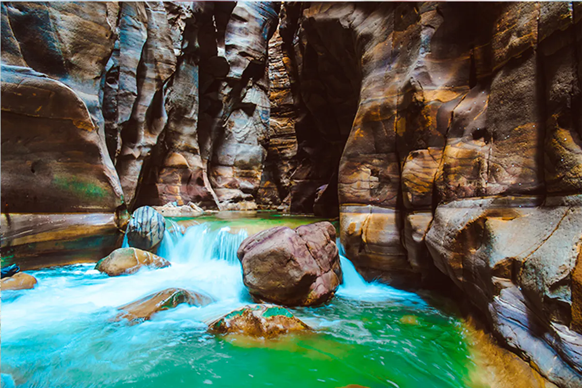 Wadi Mujib Siq Trail canyon with flowing water and rock formations, Amman.