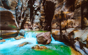 Wadi Mujib Siq Trail canyon with flowing water and rock formations, Amman.