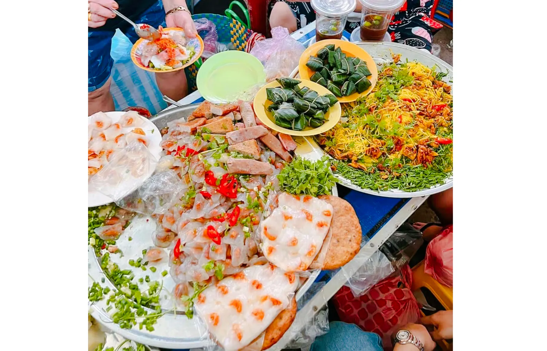 Street food spread with Vietnamese dishes in Da Nang, featuring rice paper rolls and noodles.