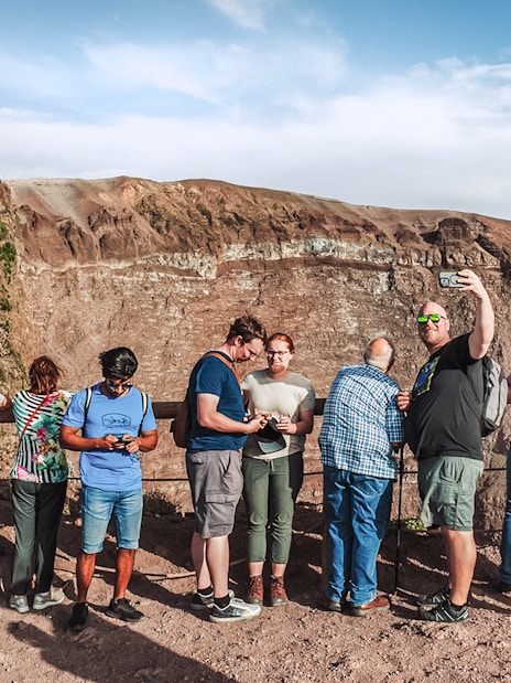 Tourists taking photos at the crater of Mount Vesuvius, Italy.