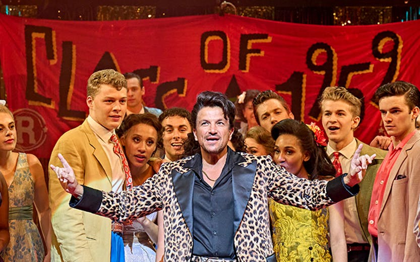 London theatre stage with audience, showcasing discounted tickets for a captivating performance.