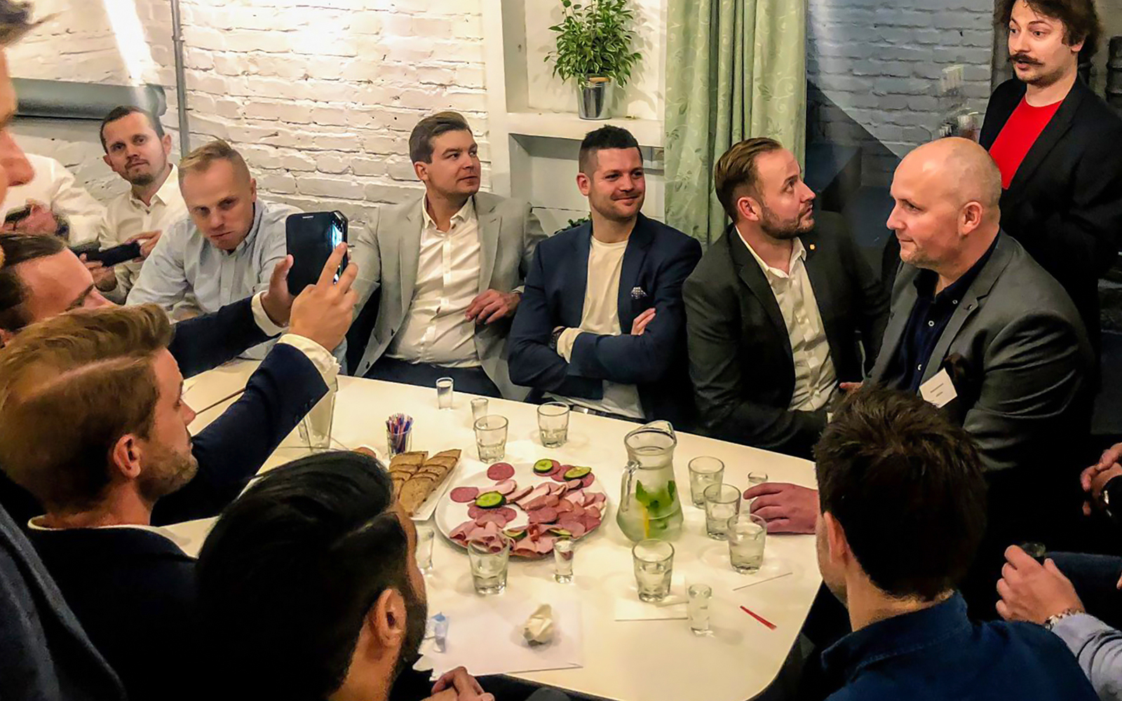 Group enjoying vodka tasting with snacks in Wroclaw.