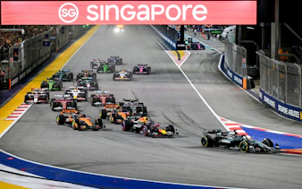 Cars racing at the Formula 1 Singapore Grand Prix night circuit.