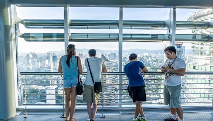 Visitors enjoying the view from Petronas Twin Towers skybridge in Kuala Lumpur.