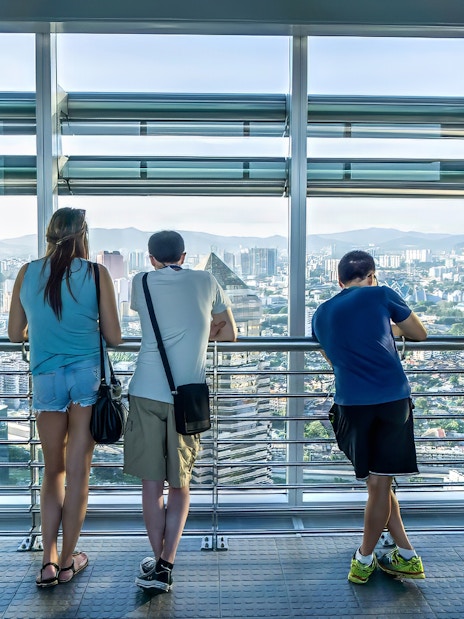 Visitors enjoying the view from Petronas Twin Towers skybridge in Kuala Lumpur.