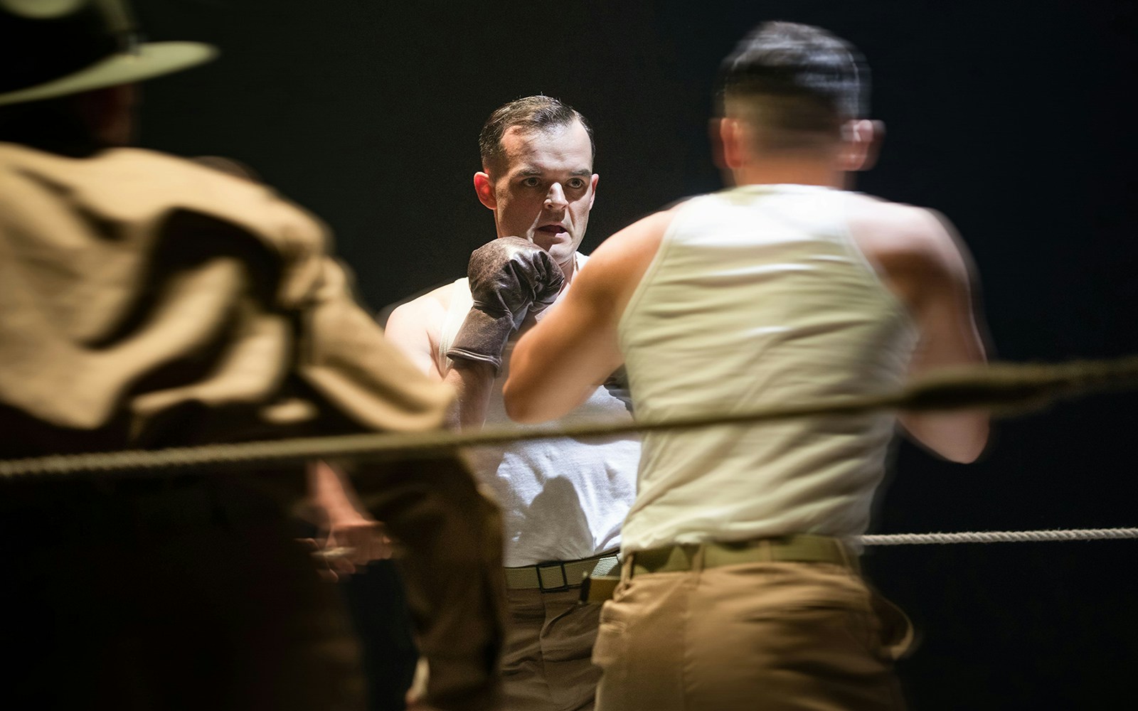 Boxing scene from "From Here To Eternity – The Musical" with two soldiers in a ring.
