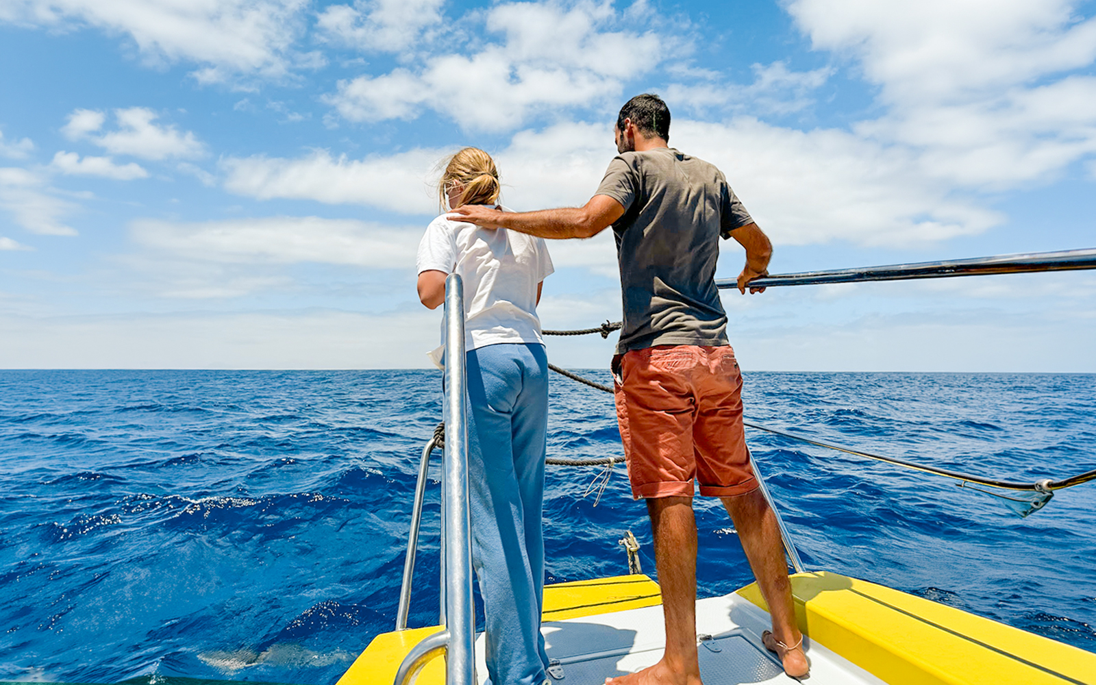 Tourists on a boat watching dolphins in the sea of Lanzarote.