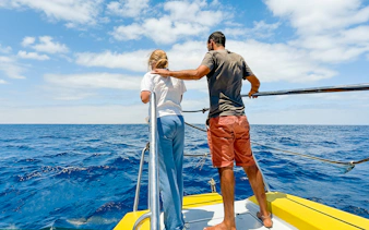 Tourists on a boat watching dolphins in the sea of Lanzarote.