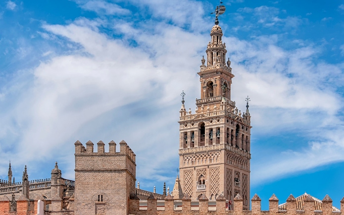 Giralda tower of Seville Cathedral against blue sky, Seville, Spain.