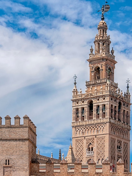 Giralda tower of Seville Cathedral against blue sky, Seville, Spain.