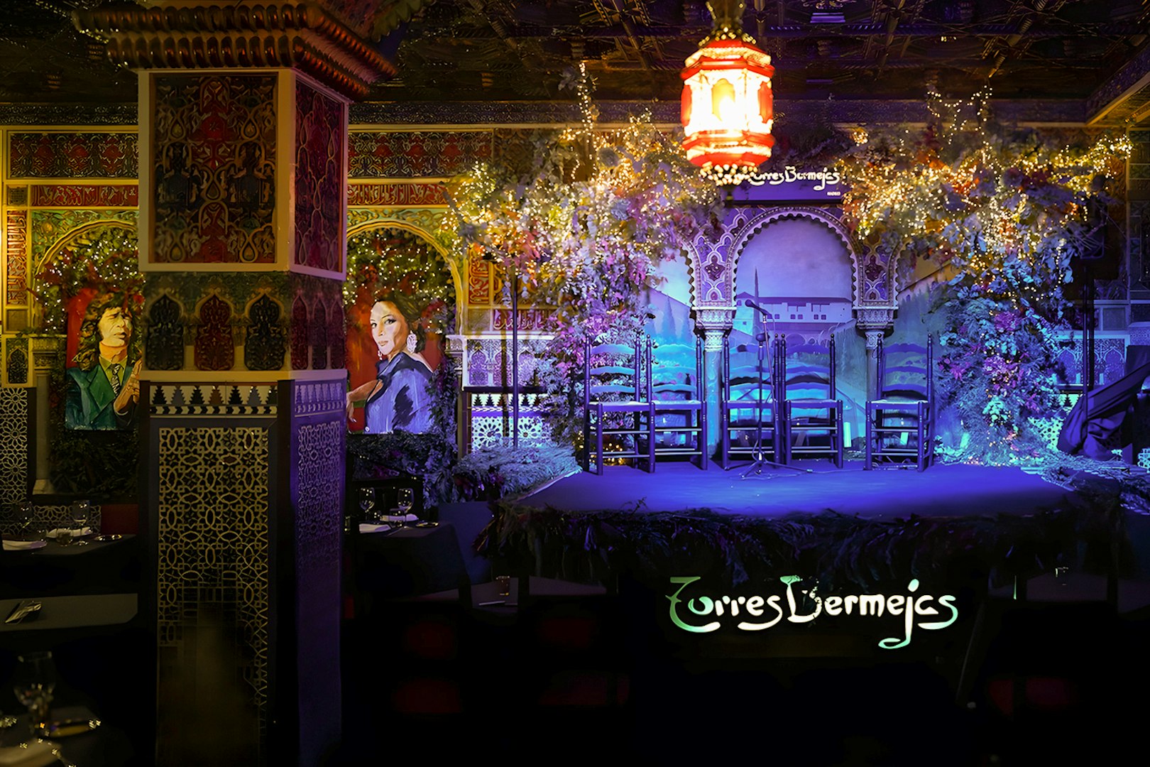 Flamenco stage at Torres Bermejas, Madrid, with ornate decor and empty chairs.