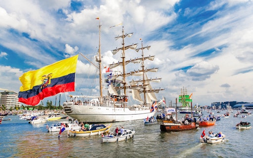 Tall ships and boats sailing during Sail Amsterdam event.