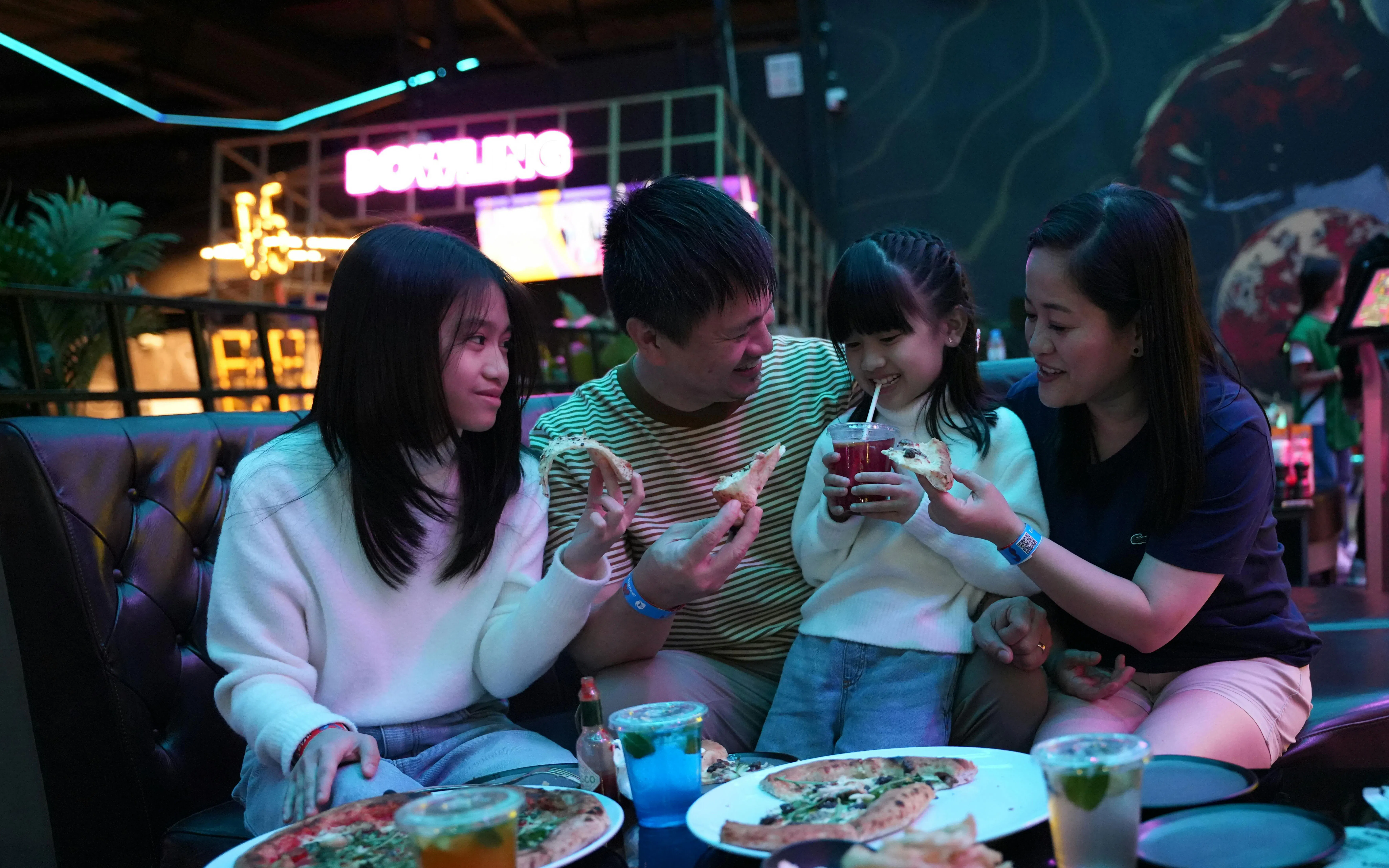 Family enjoying pizza and drinks at Loco Lounge, Loco Bear, Dubai.