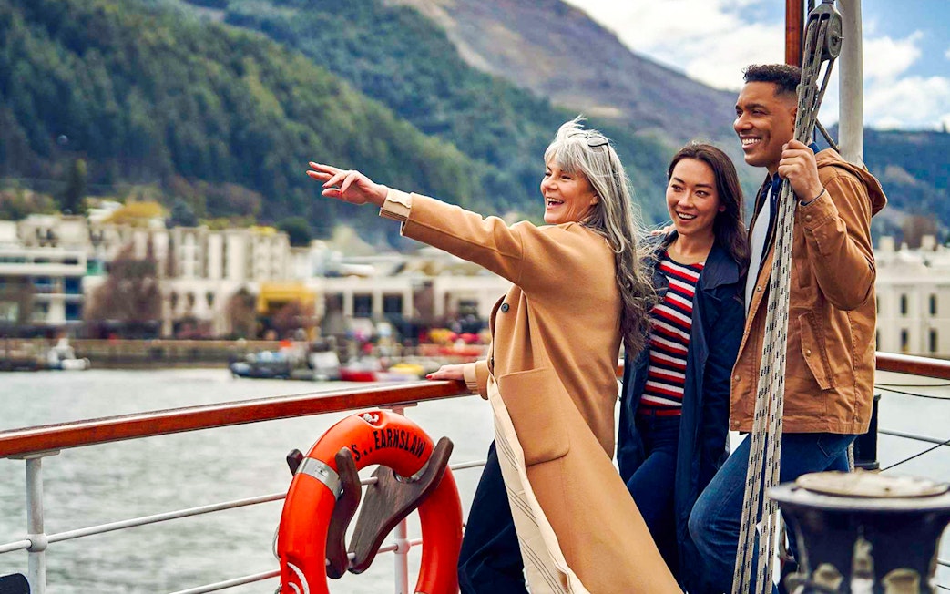 Group enjoying TSS Earnslaw Lake Cruise from Queenstown with scenic mountain views.