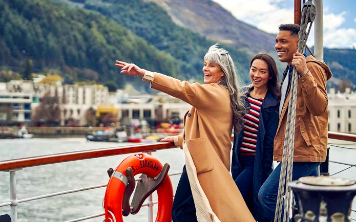 Group enjoying TSS Earnslaw Lake Cruise from Queenstown with scenic mountain views.