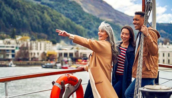 Group enjoying TSS Earnslaw Lake Cruise from Queenstown with scenic mountain views.