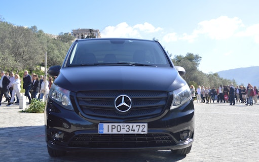 Minivan parked near Acropolis, Athens, for airport transfer service.