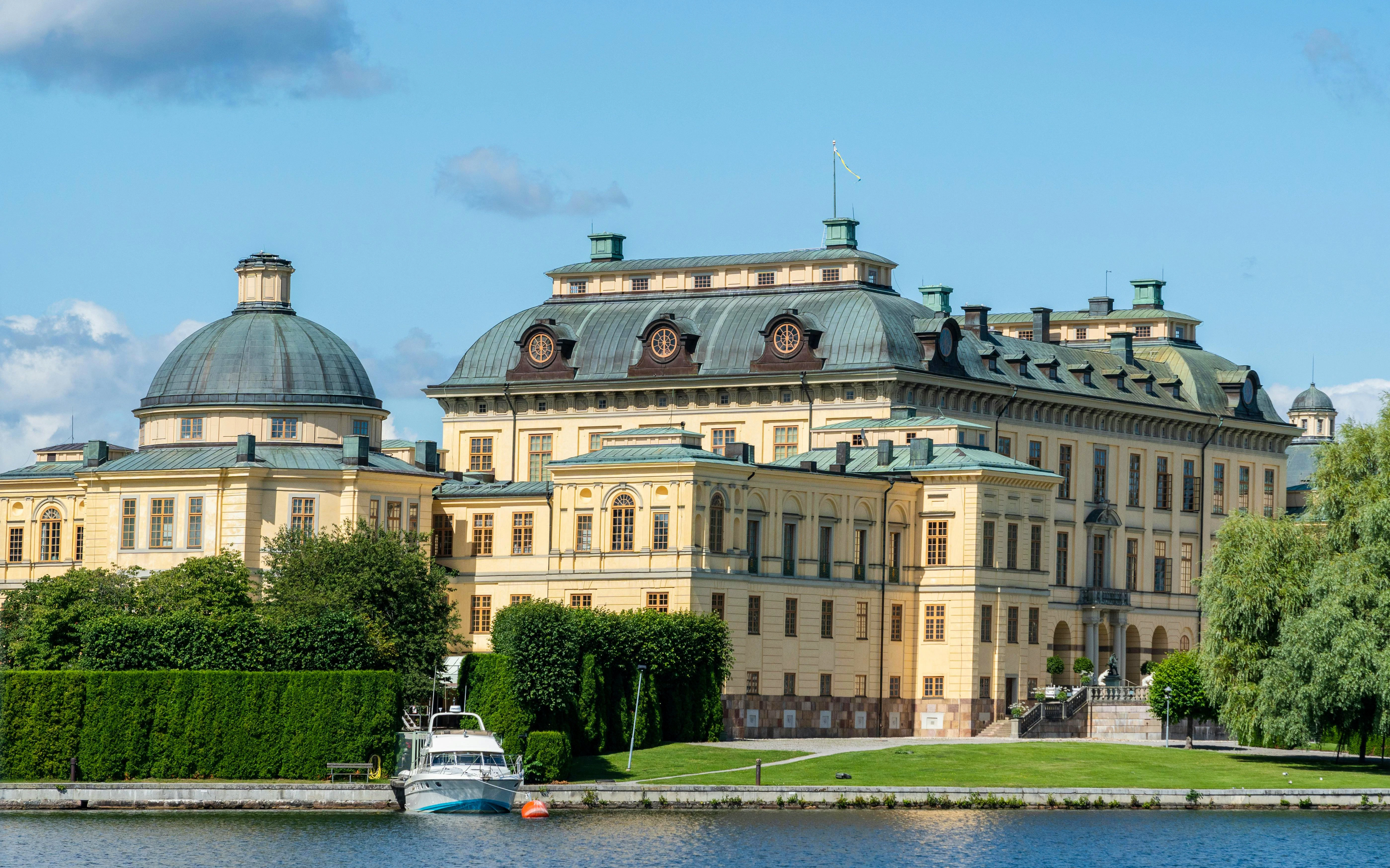 Drottningholm Palace by the water with lush greenery, Stockholm, Sweden.