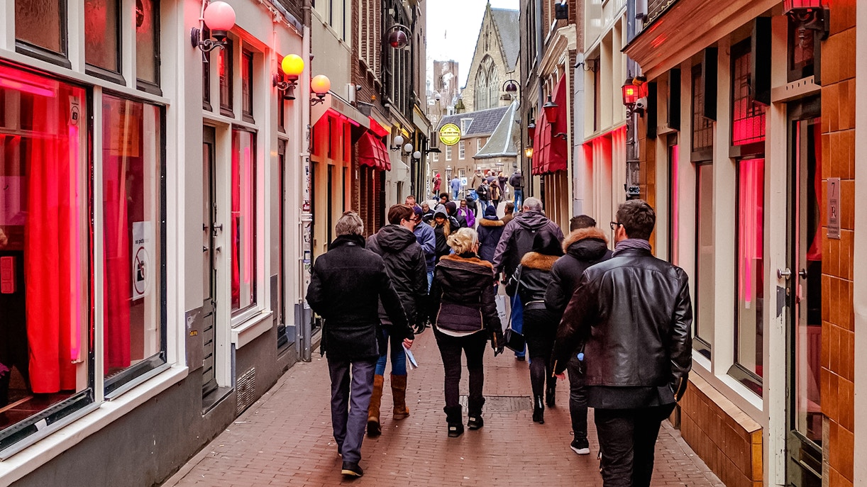 Tour group walking through Amsterdam's Red Light District.