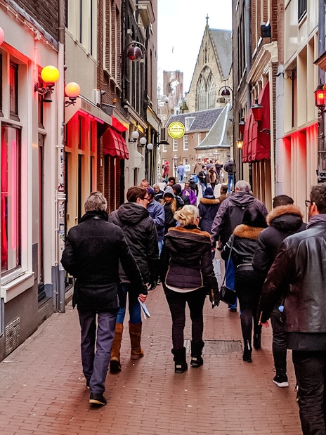 Tour group walking through Amsterdam's Red Light District.